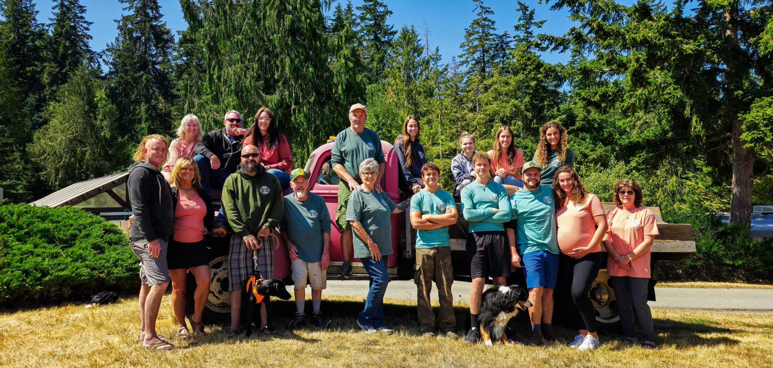 RV park staff team members standing together in front of a vintage truck